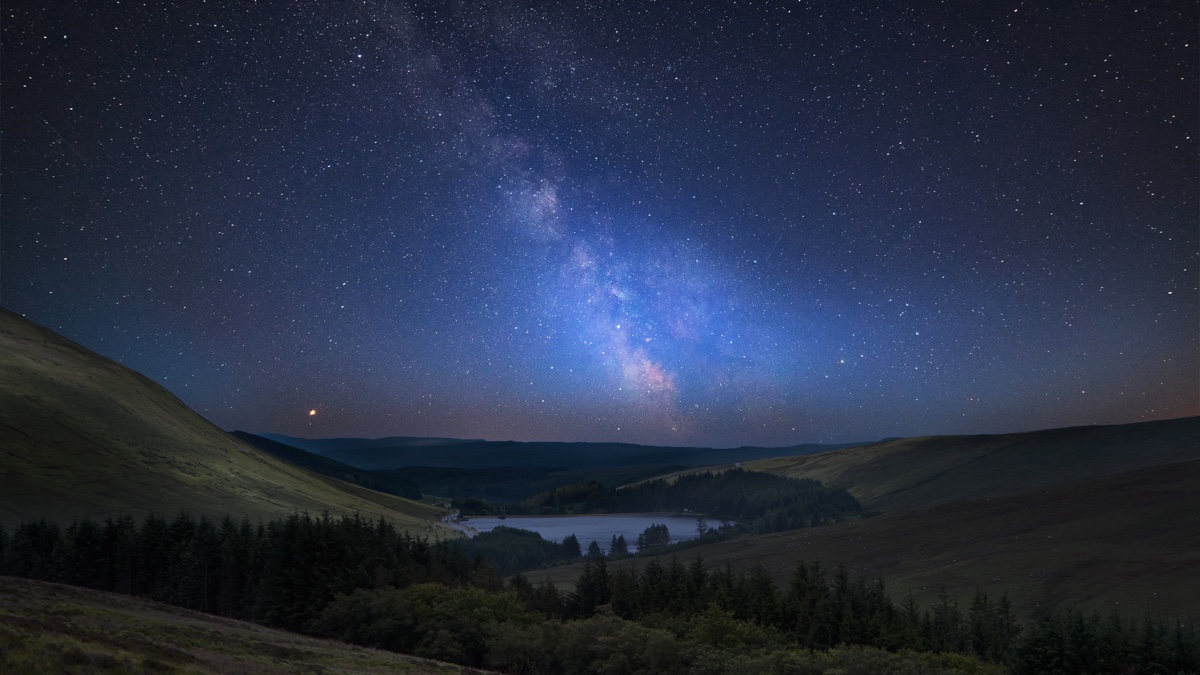 The Milky Way over the mountains of the Brecon Beacons at night