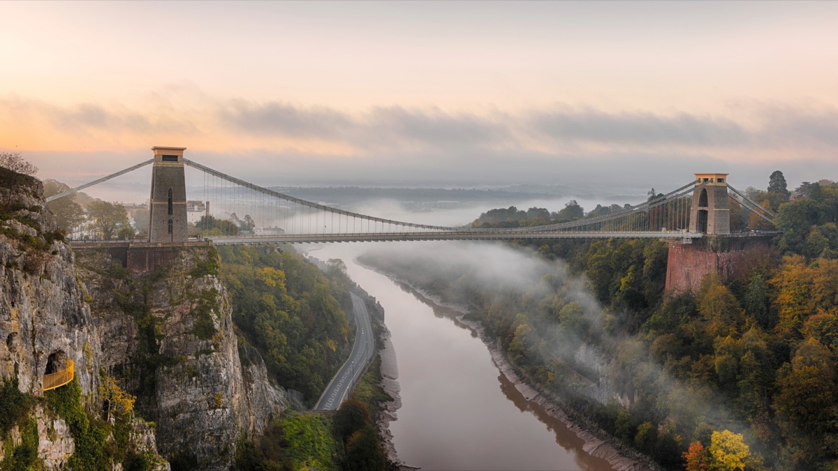 Clifton Suspension Bridge above the misty Avon Gorge at sunrise