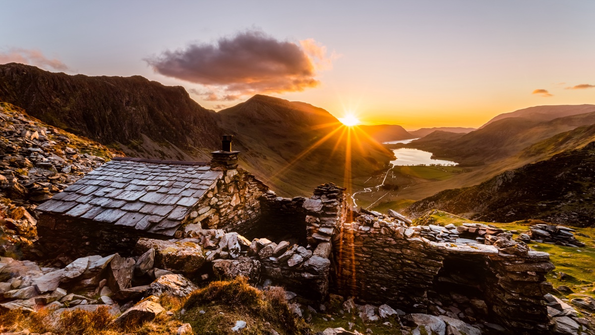 Sunset breaking over the fells from Warnscale Bothy above Buttermere, Cumbria