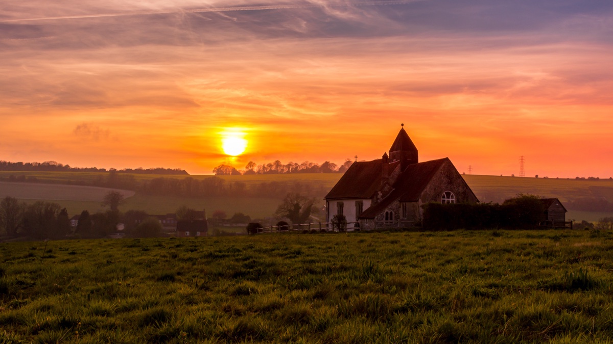 Sunset over the South Downs at Idsworth, with St Hubert's church alone in a Hampshire field