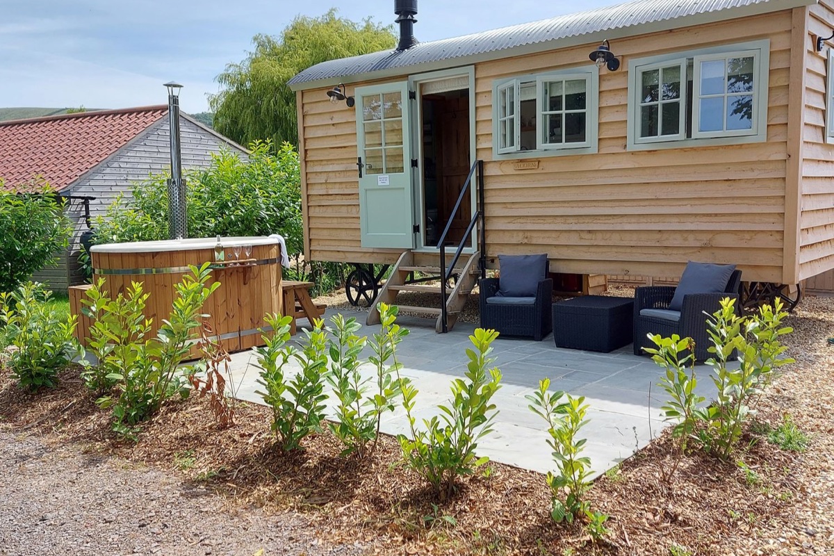 Acorn timber cabin with hot tub and patio seating in Bleadon