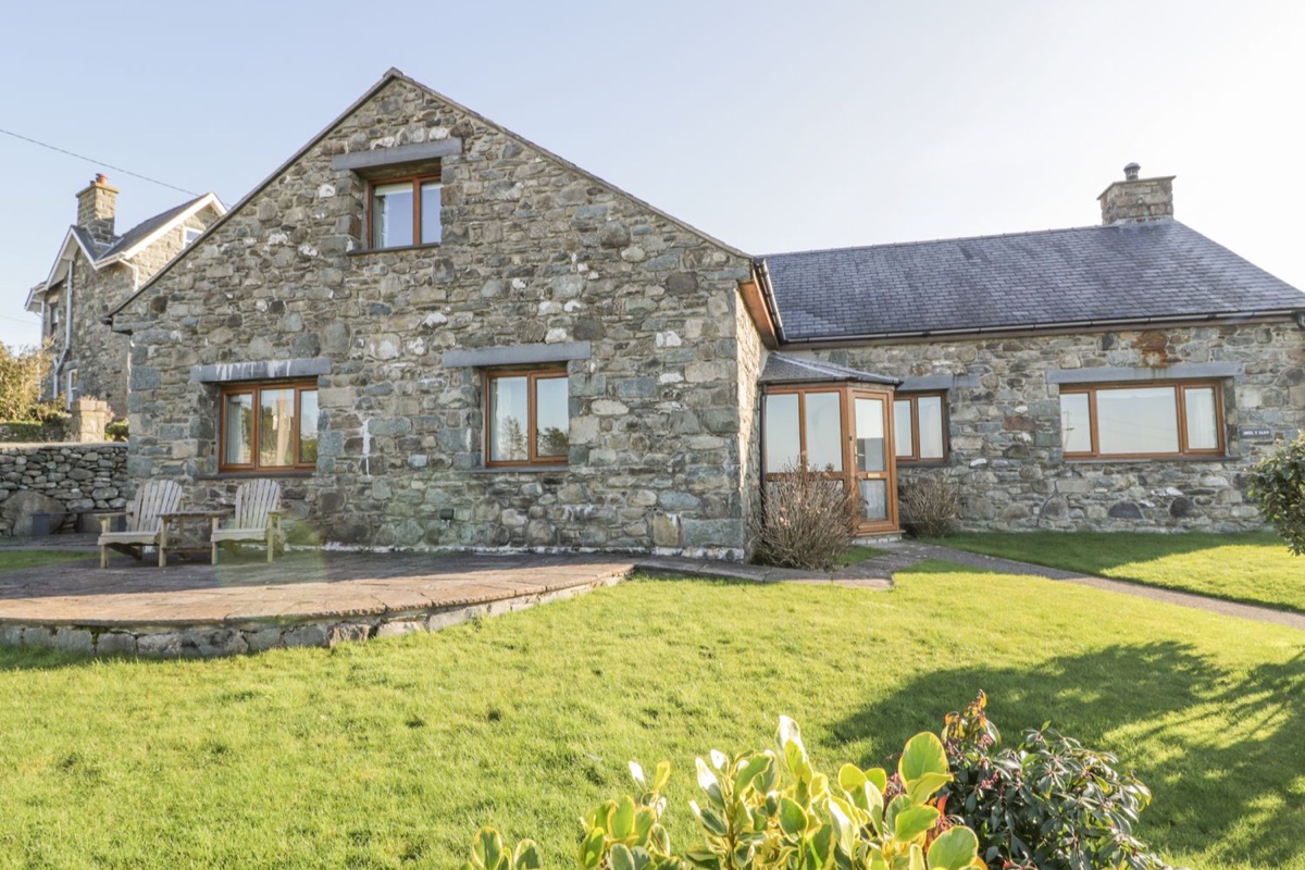 Awel Y Llan exterior with garden and countryside around the house