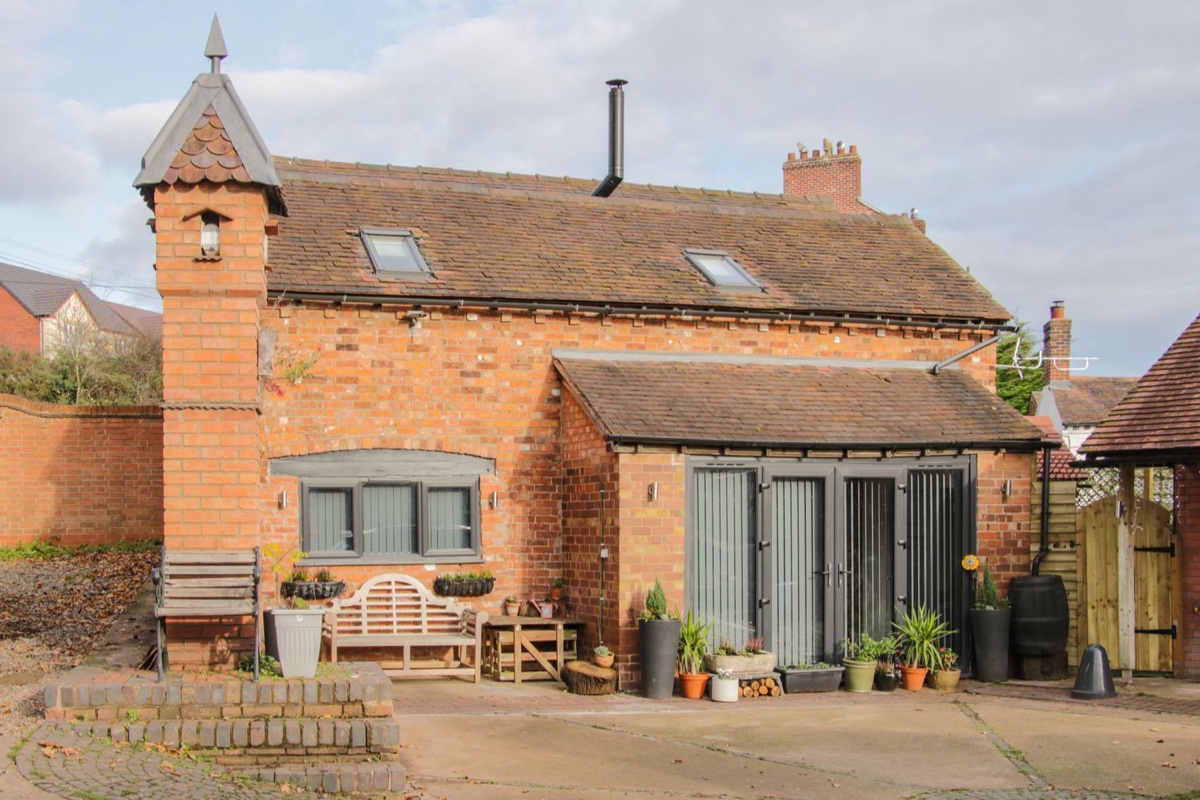 Bank House Barn brick exterior with courtyard seating