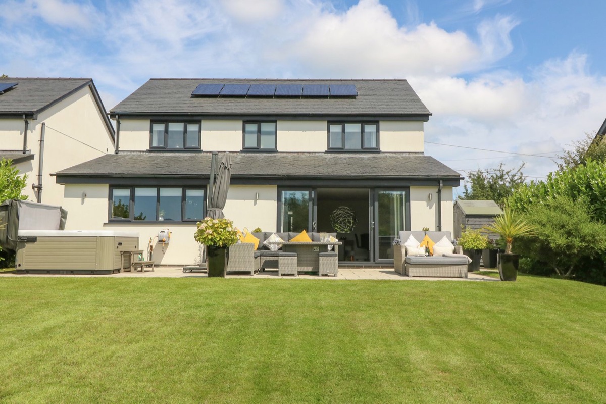 Berllan garden with house, seating and hot tub