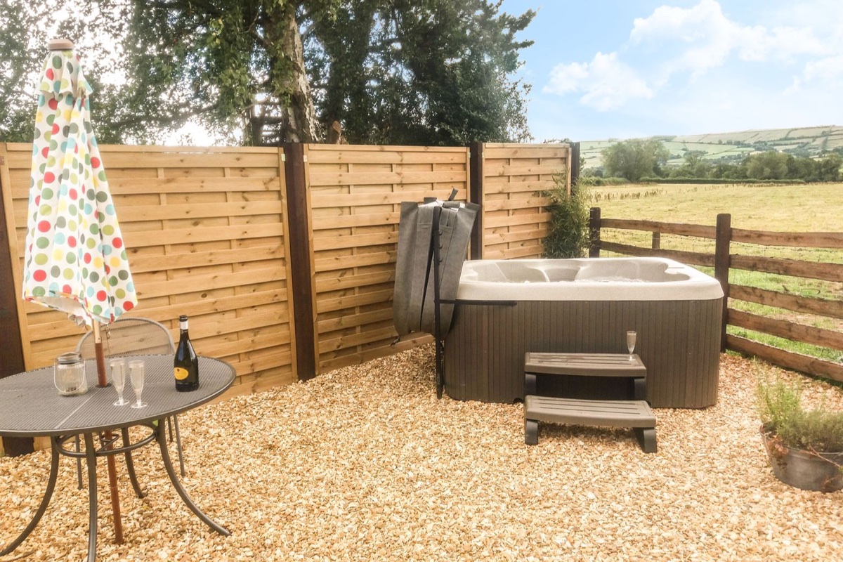 Bicton Lodge hot tub terrace with open countryside views