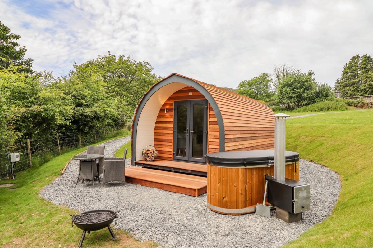 Briallen pod exterior with wooden hot tub and outdoor seating