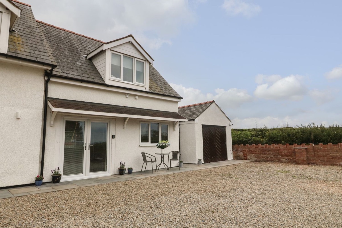 Bryn Eglwys Bach cottage exterior and patio