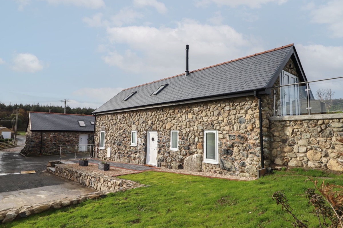 Bryn Eglwys Cottage stone exterior with glass balcony