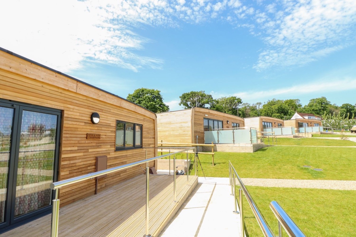 Champagne lodge exterior and deck across the Pondwell lawns