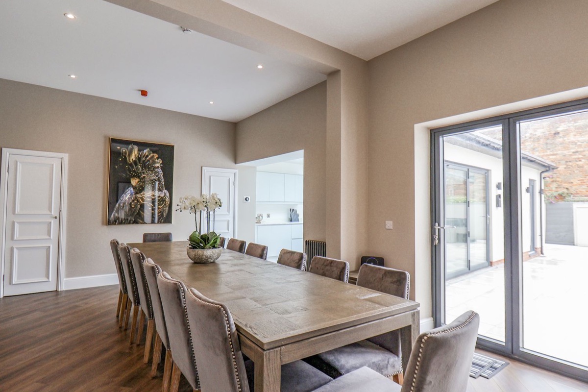 Church View dining room opening onto a large paved courtyard