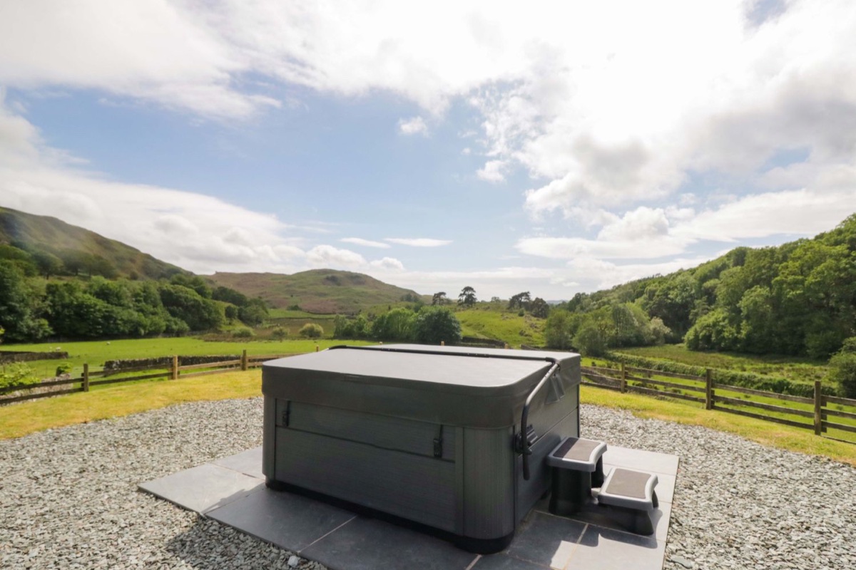 Hot tub on a raised deck with a Coniston Old Man fell panorama at Copper Beech Cottage