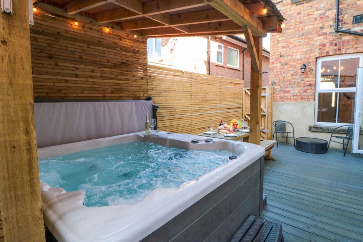 Coronation House covered hot tub and decked courtyard