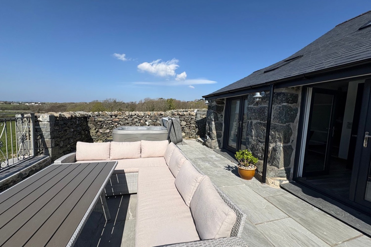 Gaerau Bach stone exterior with patio seating and hot tub