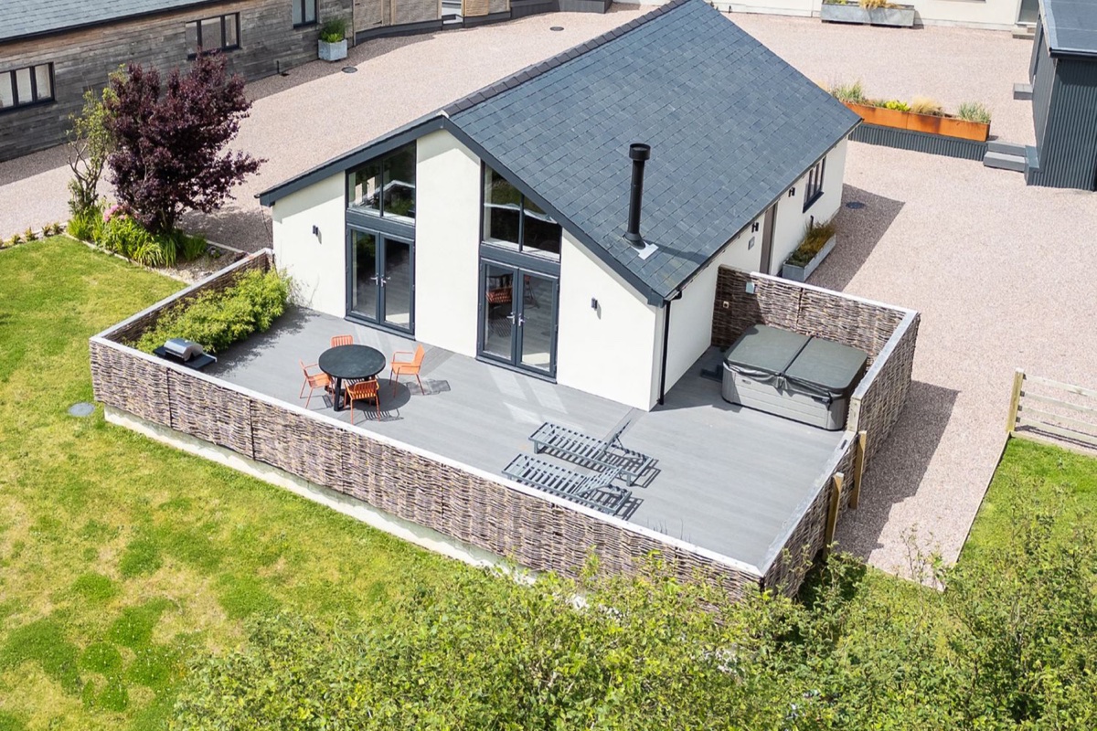 Garden House patio with hot tub, dining table and loungers