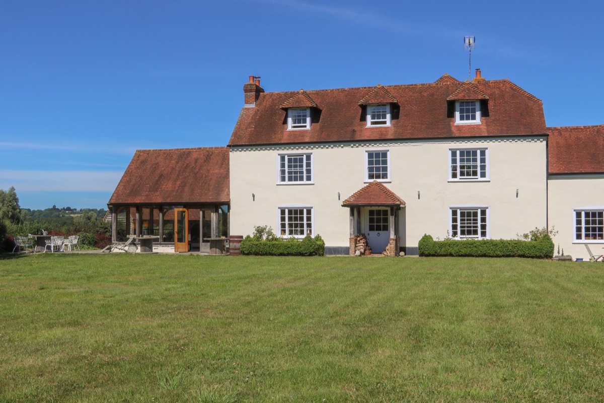 Groomes Country House exterior with lawn and countryside beyond