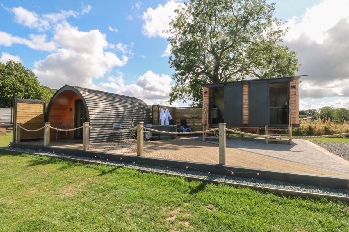 Hawkstone pod, deck, hot tub and shower block in open countryside