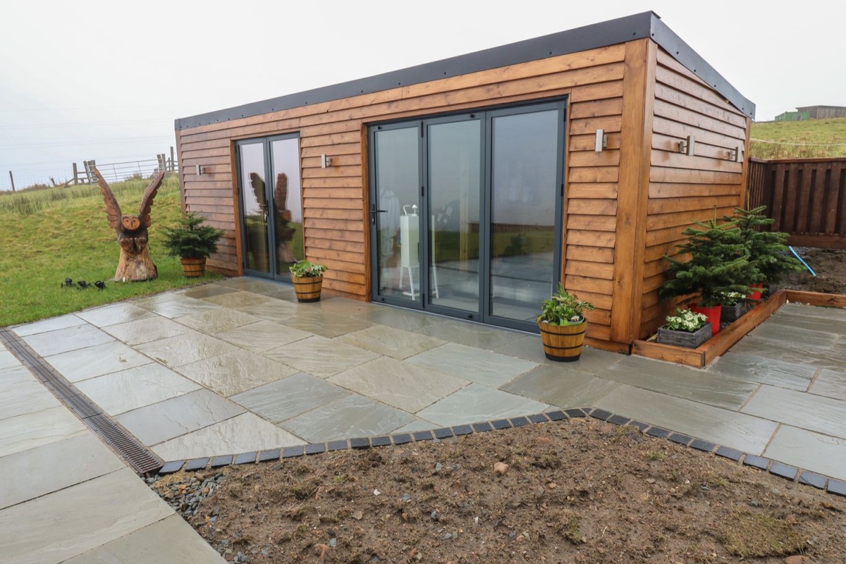 Height End Farm Log Cabin exterior with sliding doors and patio