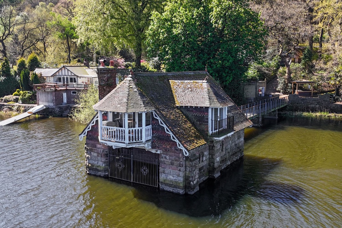 Stone boathouse set out over the water at Lady Of The Lake, Rudyard Lake