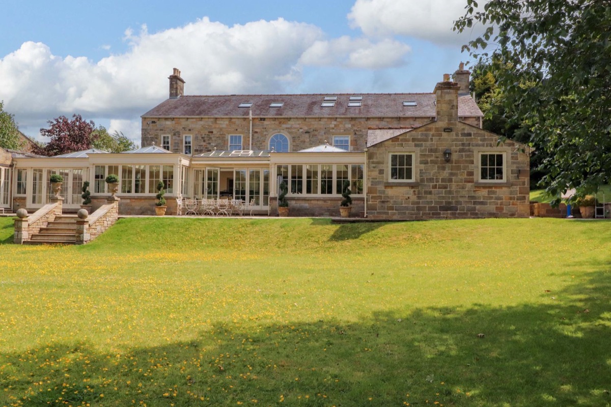 Laithe House stone exterior with lawn and garden steps