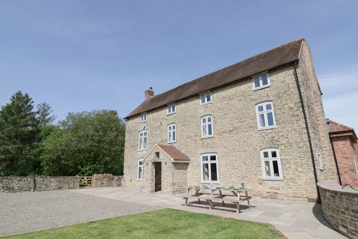 Lea Farm House stone exterior with garden and countryside around it