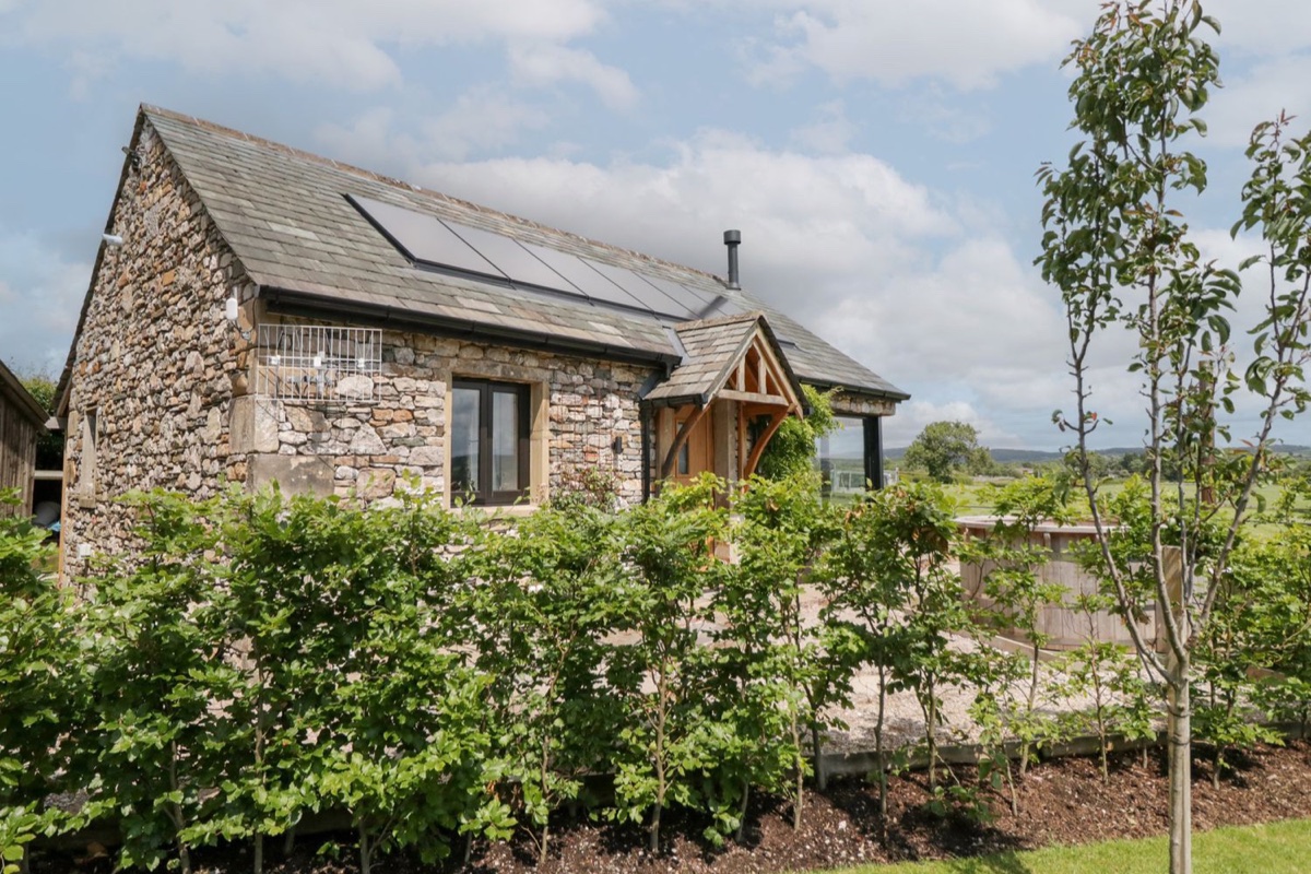 Lindeth Croft stone exterior with solar panels and planting