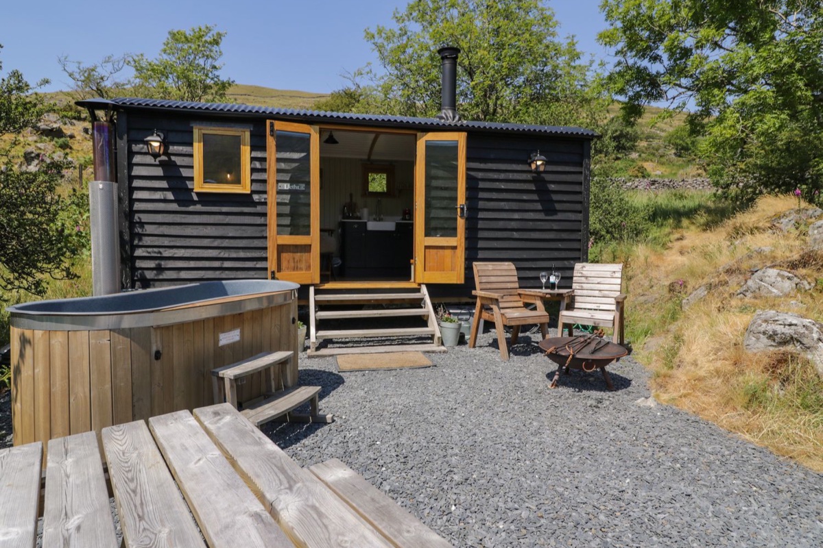 Llethr Shepherds Hut exterior with hot tub and hillside setting