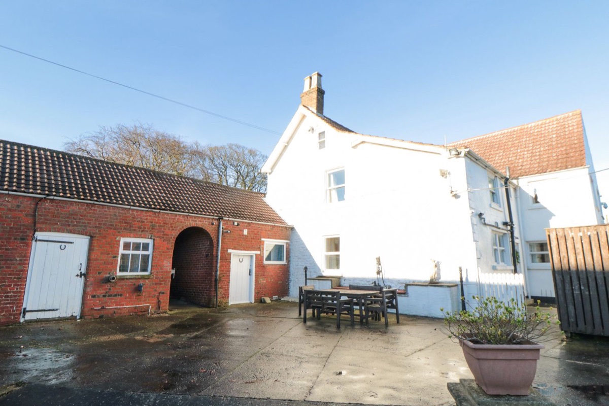 Manor Farmhouse white farmhouse and red-brick outbuildings around a courtyard