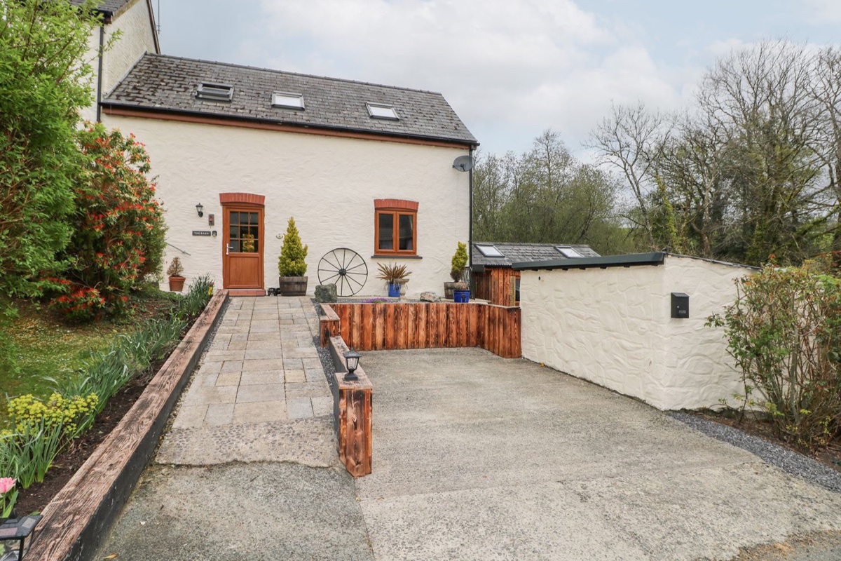 Mill Barn Denant white stone barn conversion with a paved patio near Haverfordwest