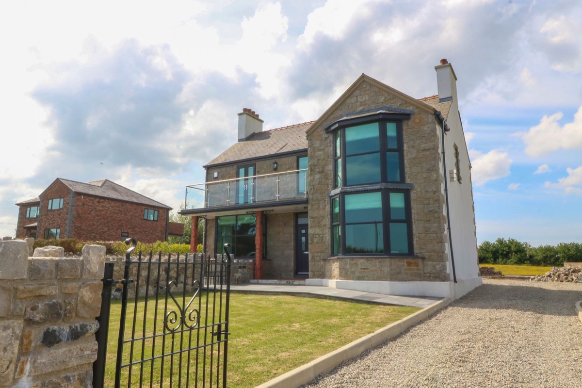 Morawelon stone-fronted house with tall sea-facing window