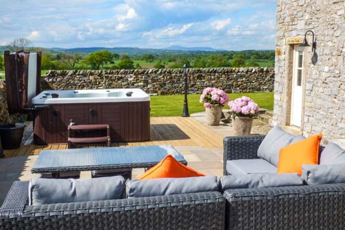 Ox Hey Barn patio with hot tub, outdoor sofa and countryside views