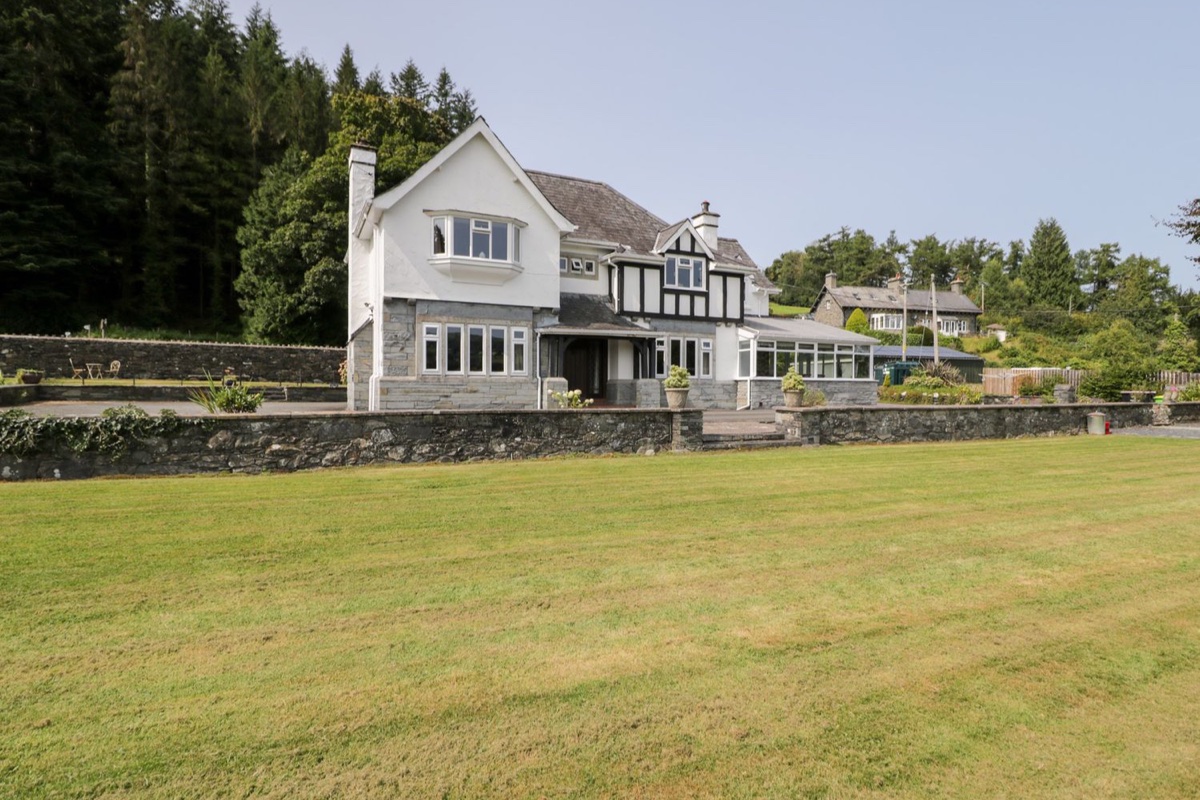 Pengwern exterior with lawn and trees around the house