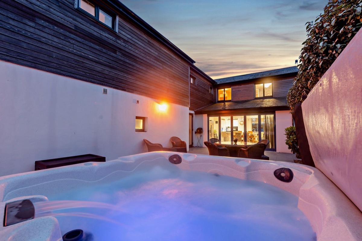 Evening hot tub in the courtyard with Sea Haze lit beyond