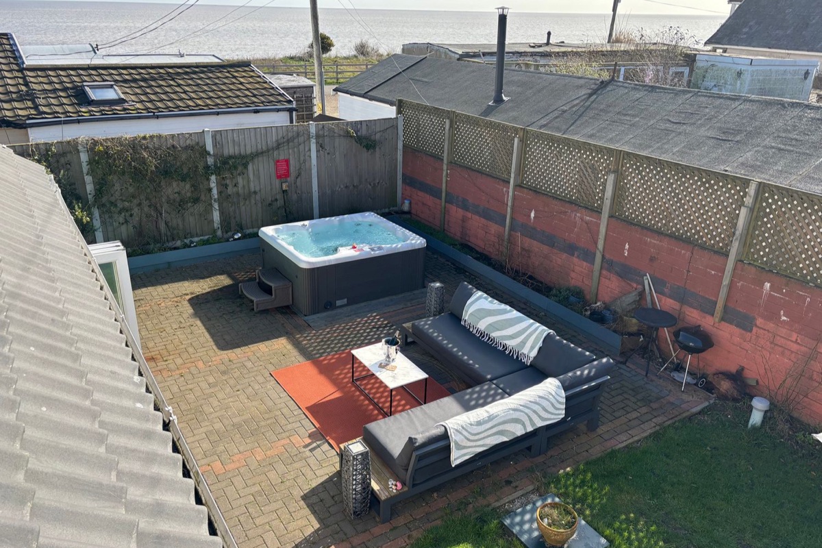 Hot tub and seating in the enclosed courtyard at Seaview