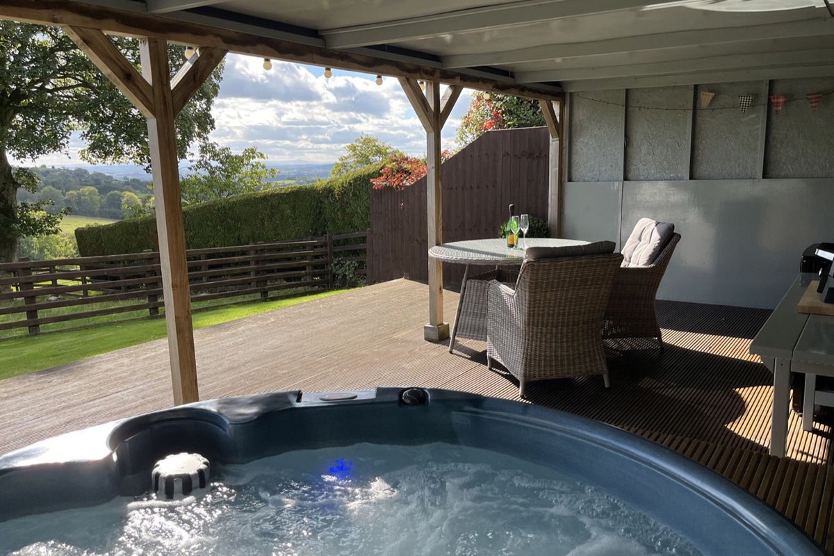 Shepherds Cabin hot tub under cover with open countryside views