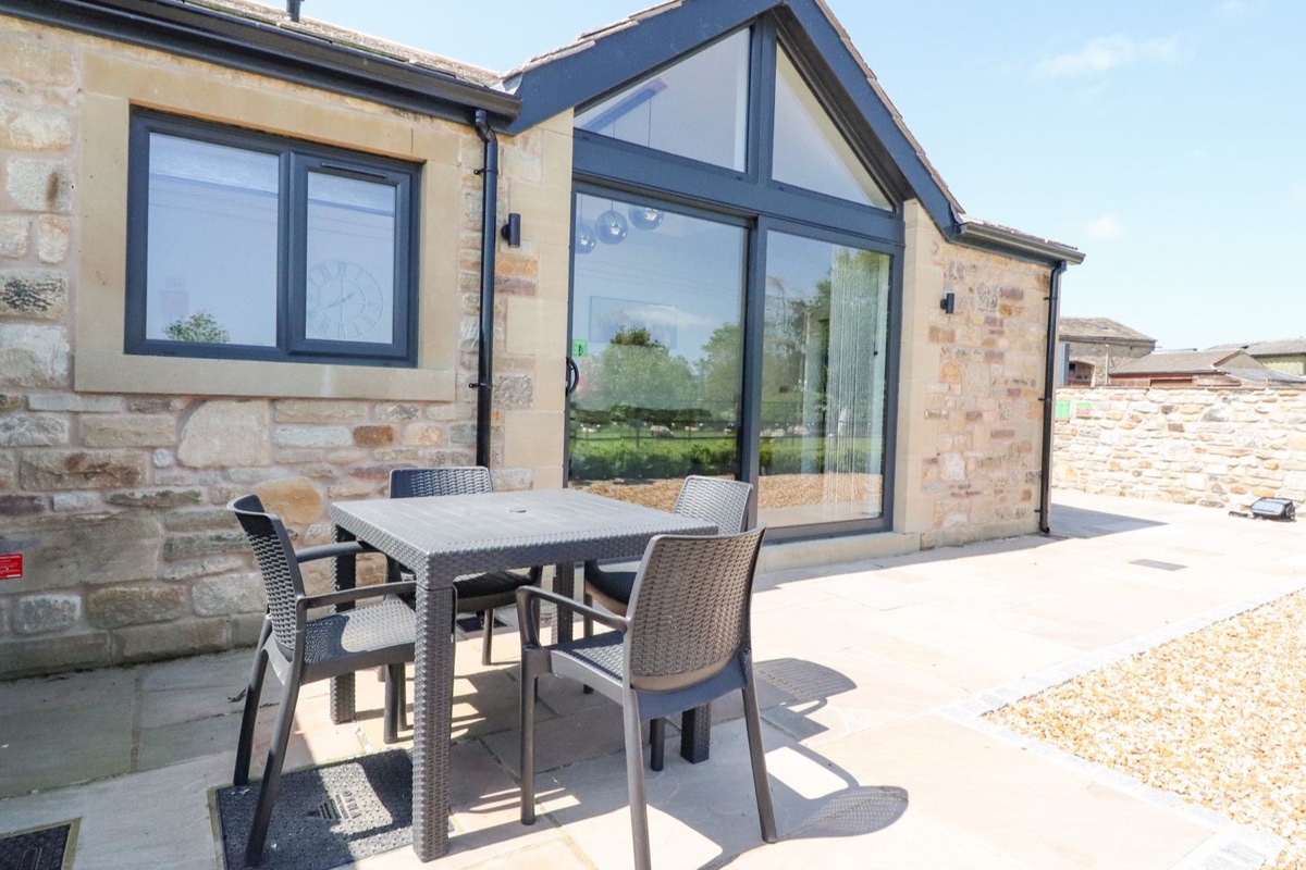 Skirden View patio table beside large glass windows