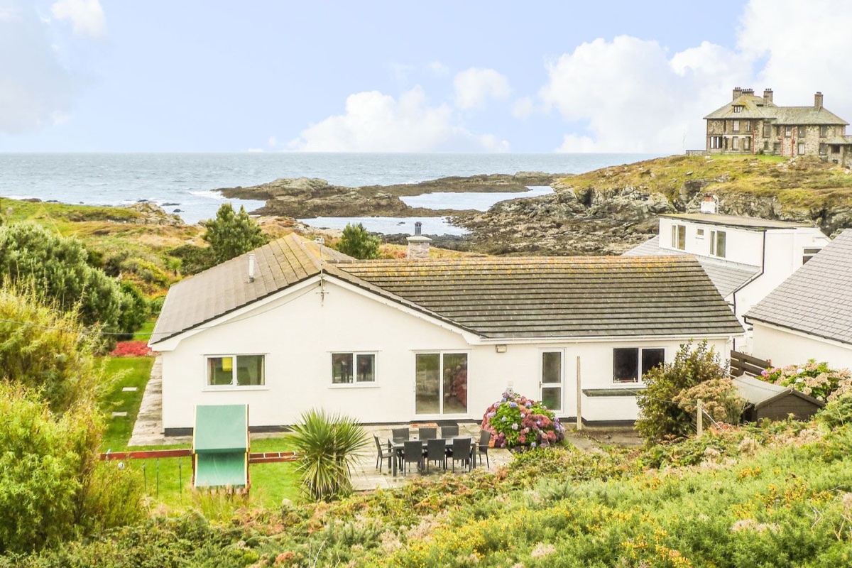 The Beach House Trearddur Bay exterior by rocky coastline