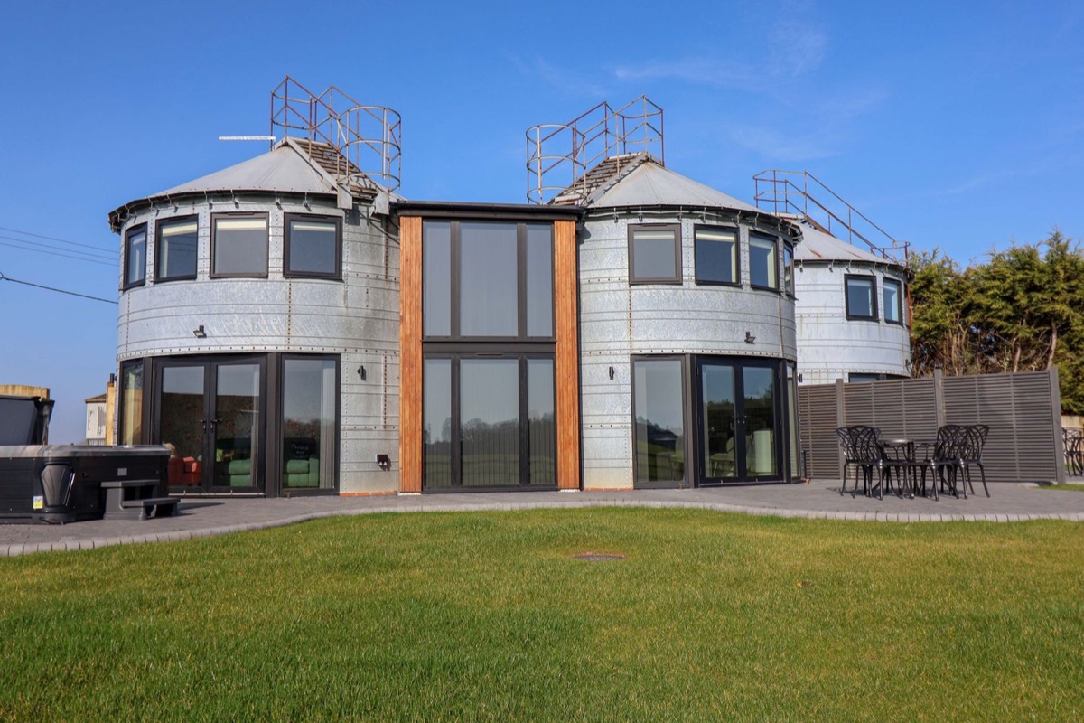 Converted Corn Silo with round metal silos and a patio