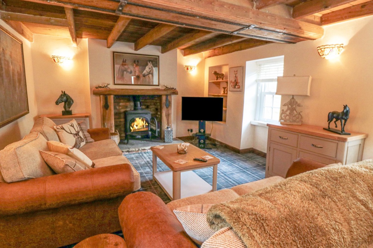 The Nook at 29 High Street sitting room with beams and lit stove
