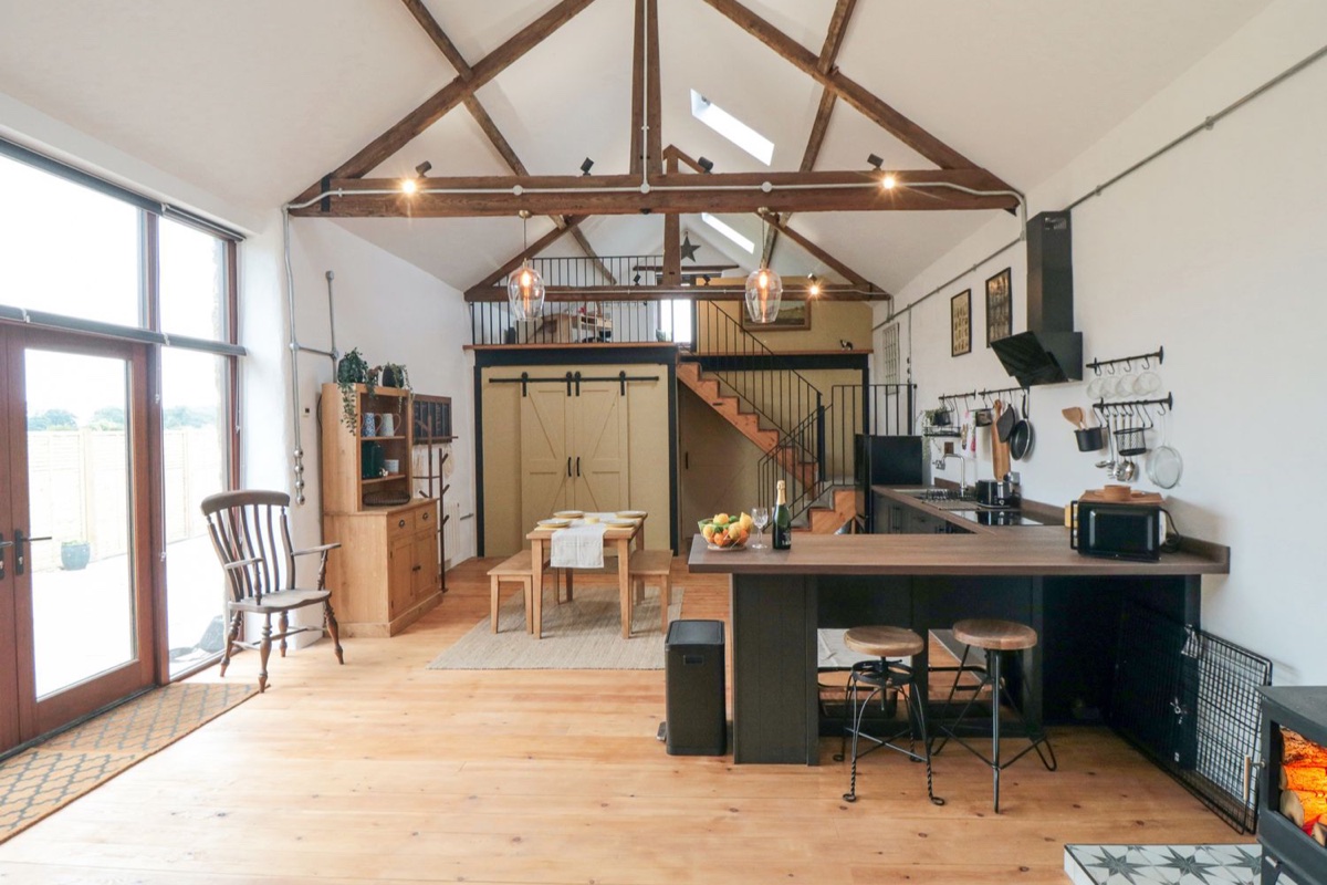 The Old Workshop vaulted open-plan room with beams, kitchen and dining table