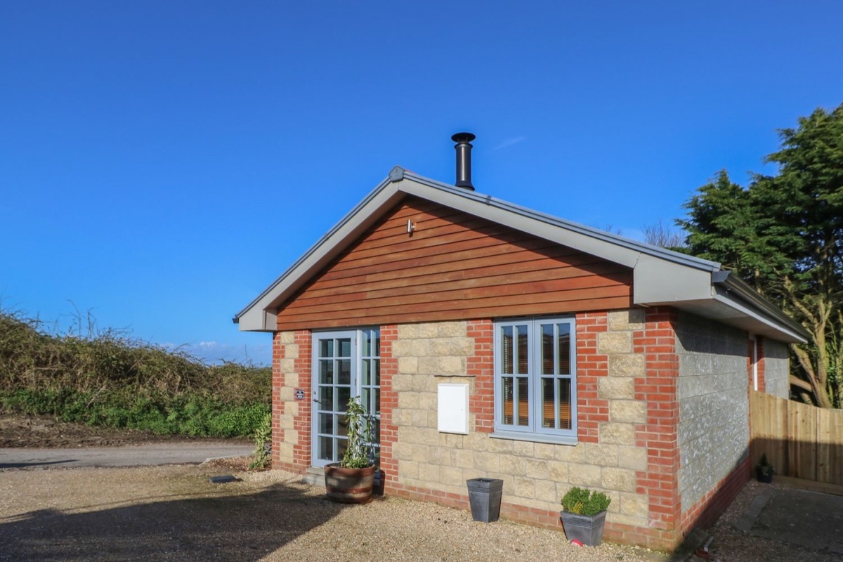 The Pepper Pot Retreat stone cottage exterior beneath a blue sky