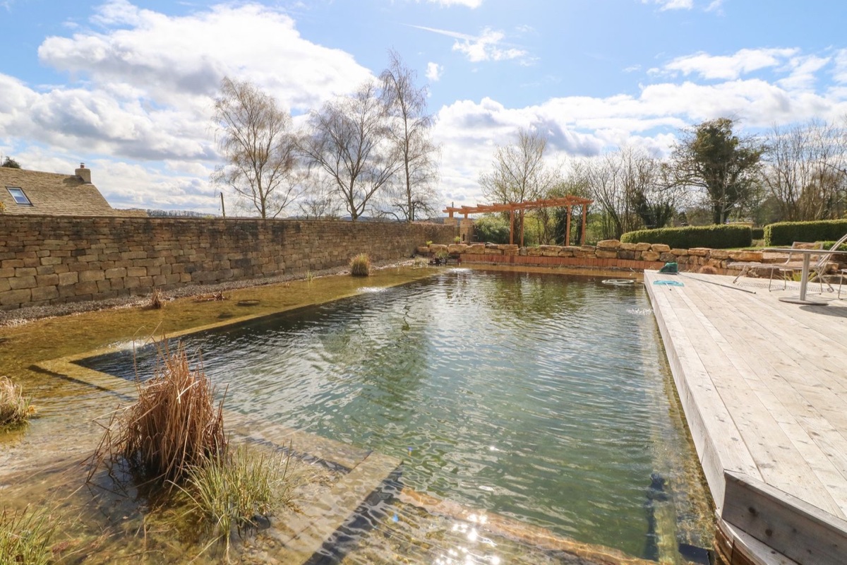 Natural pool and deck with countryside views at Tickmorend Farm