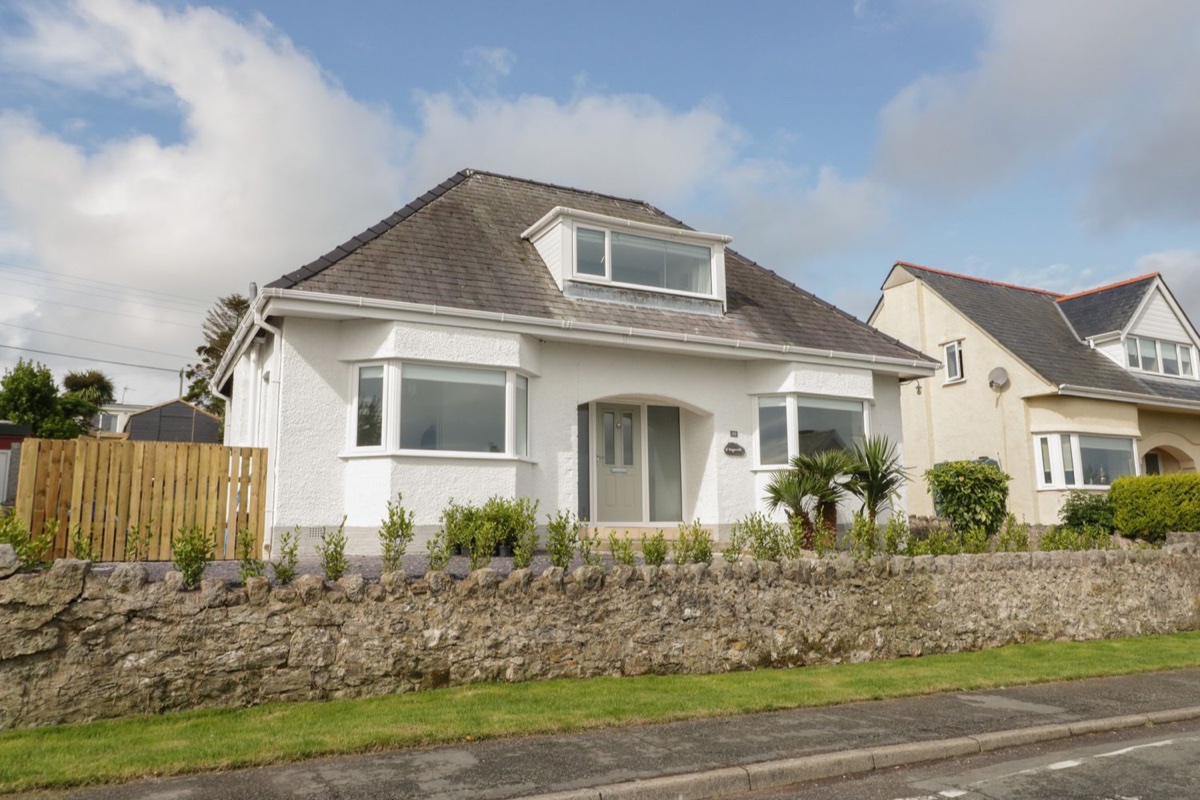 Y Gogarth detached house exterior behind a stone wall