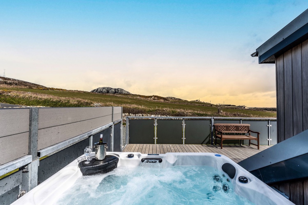 Ysbryd y Mynydd hot tub with hills beyond the deck